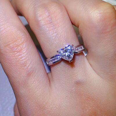 a close up of a person's hand with a ring on it