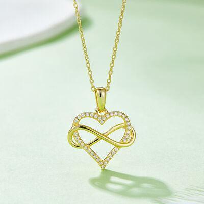 a gold necklace with a heart shaped pendant