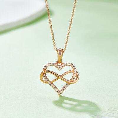 a gold necklace with a heart shaped pendant