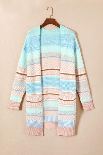 a blue and pink striped sweater hanging on a hanger