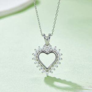 a necklace with a heart shaped pendant on a chain