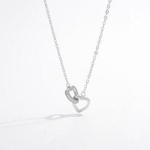 a silver necklace with a heart on it