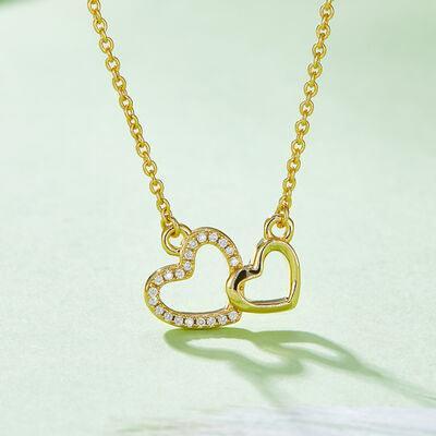 a gold necklace with two hearts on it