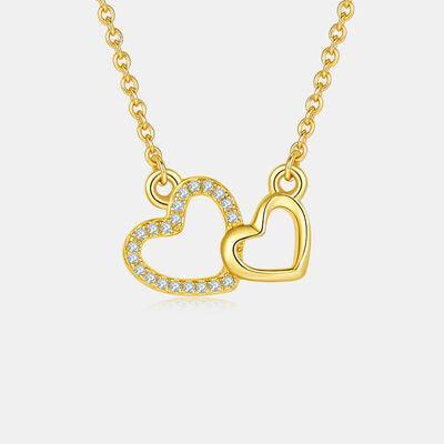 a gold necklace with two hearts on it