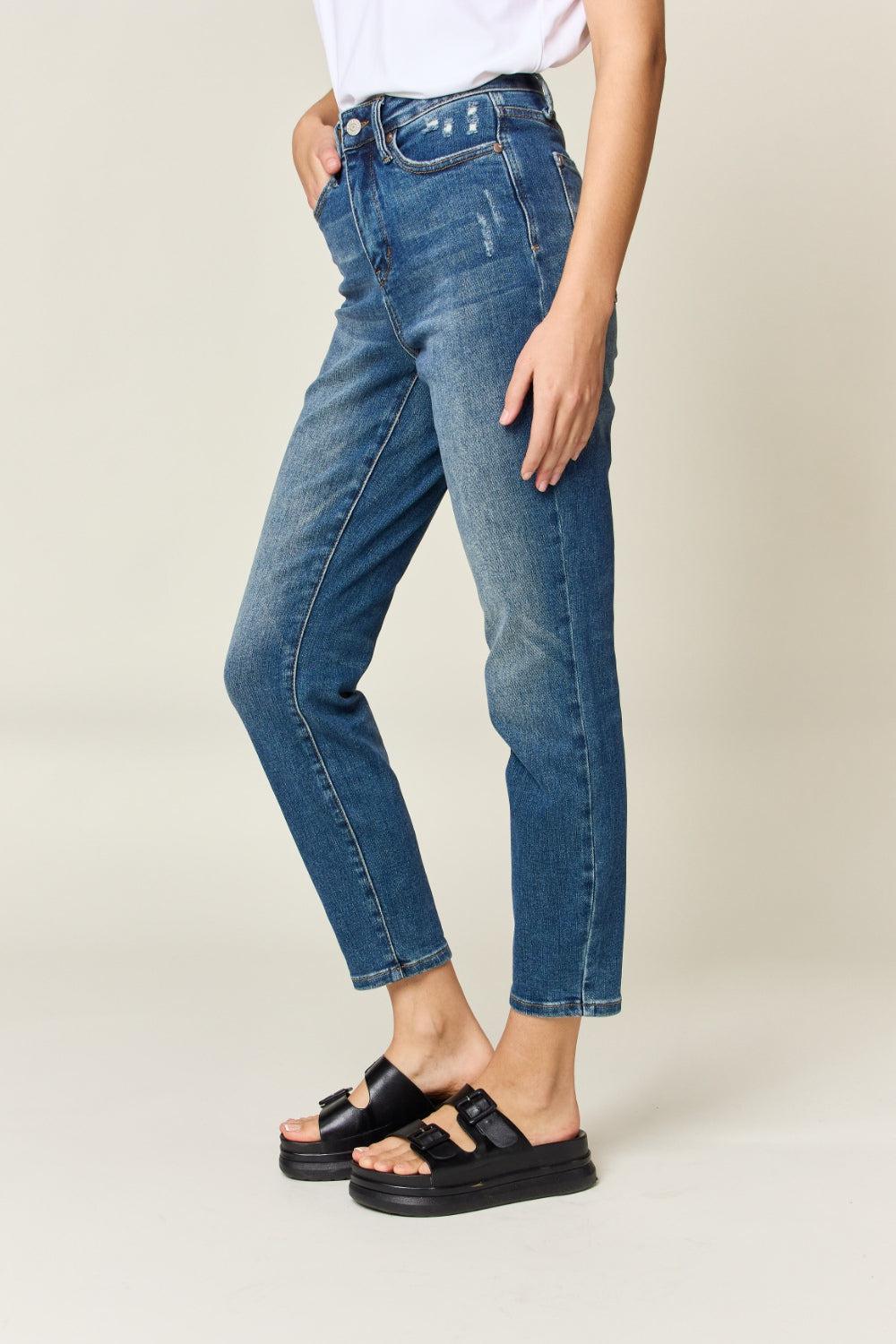 a woman wearing a white shirt and jeans