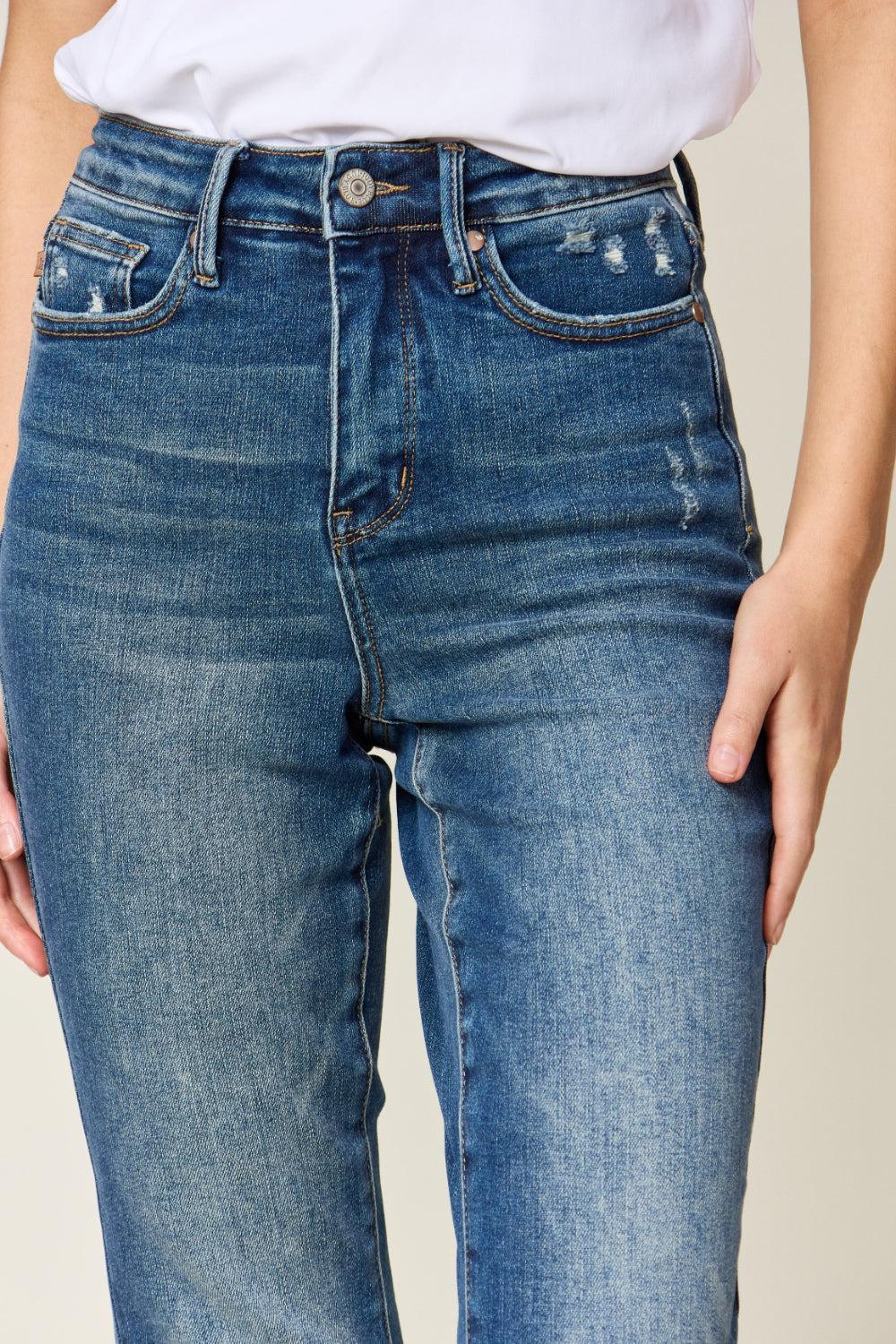 a woman wearing a white shirt and jeans