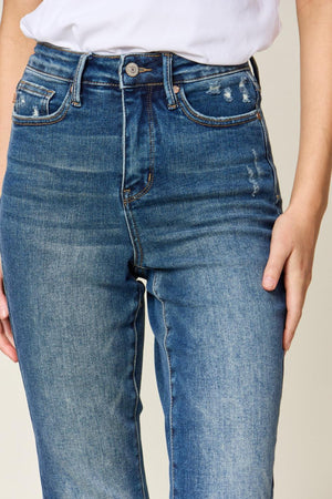 a woman wearing a white shirt and jeans