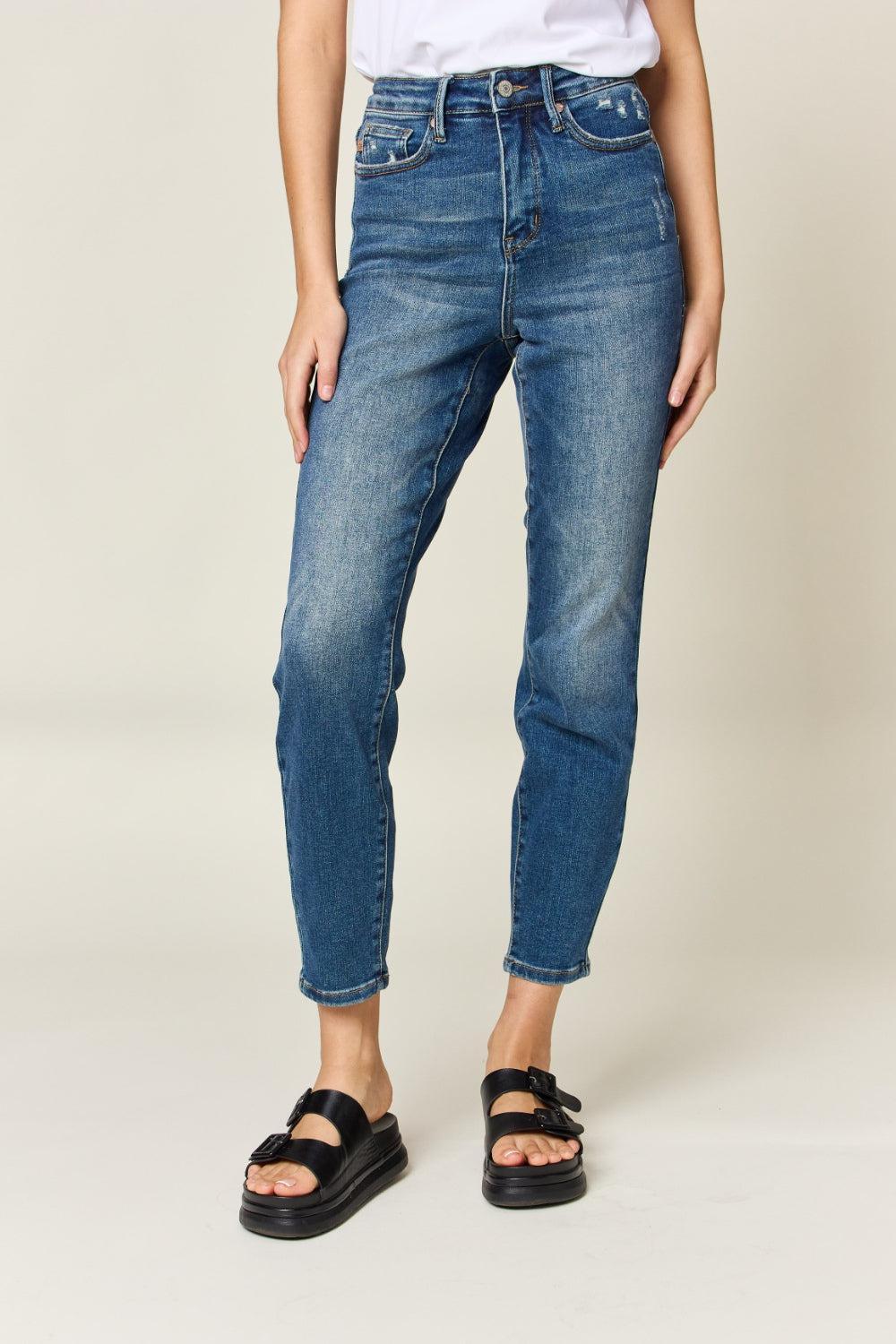 a woman wearing a white shirt and blue jeans