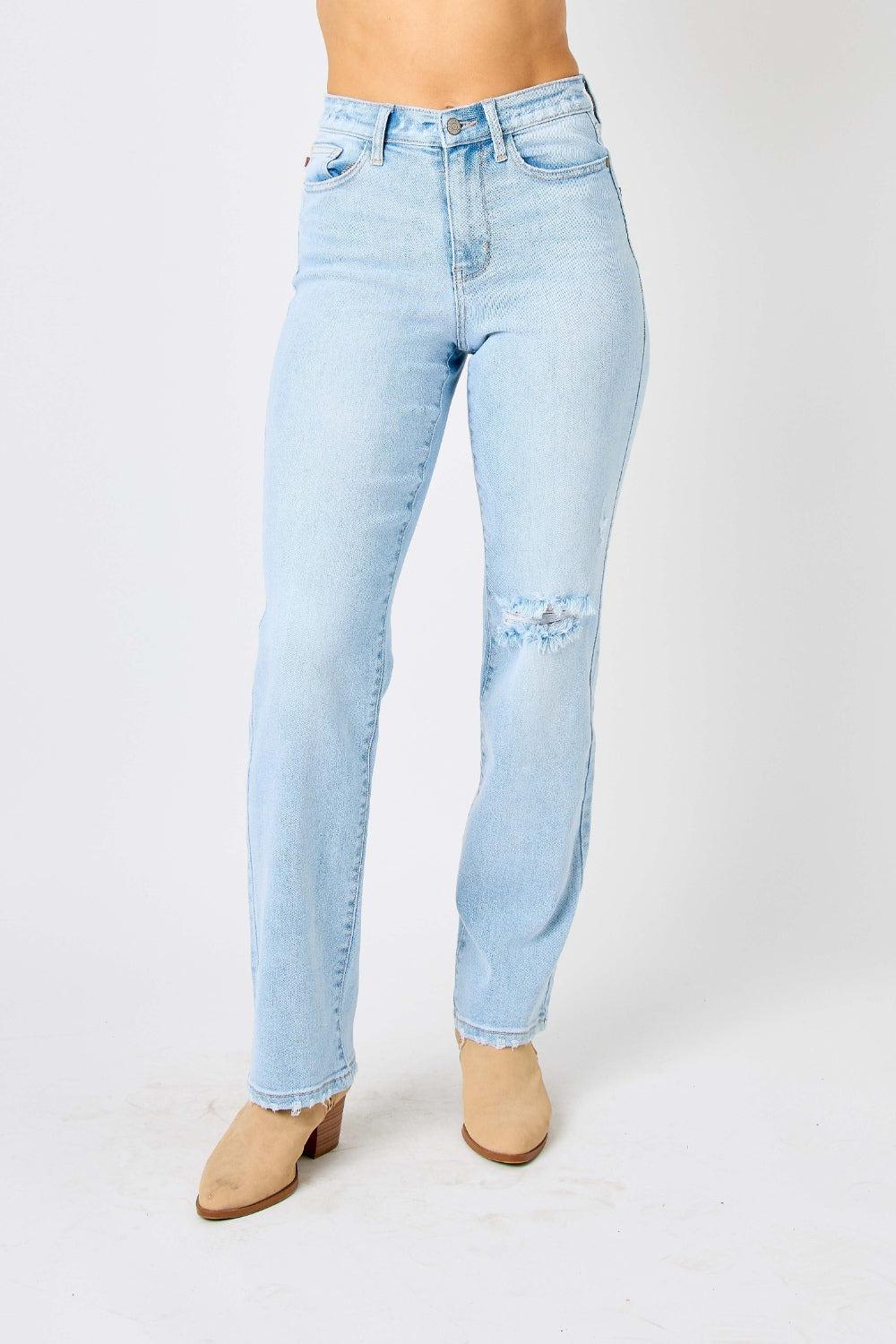 a woman in a white top and blue jeans