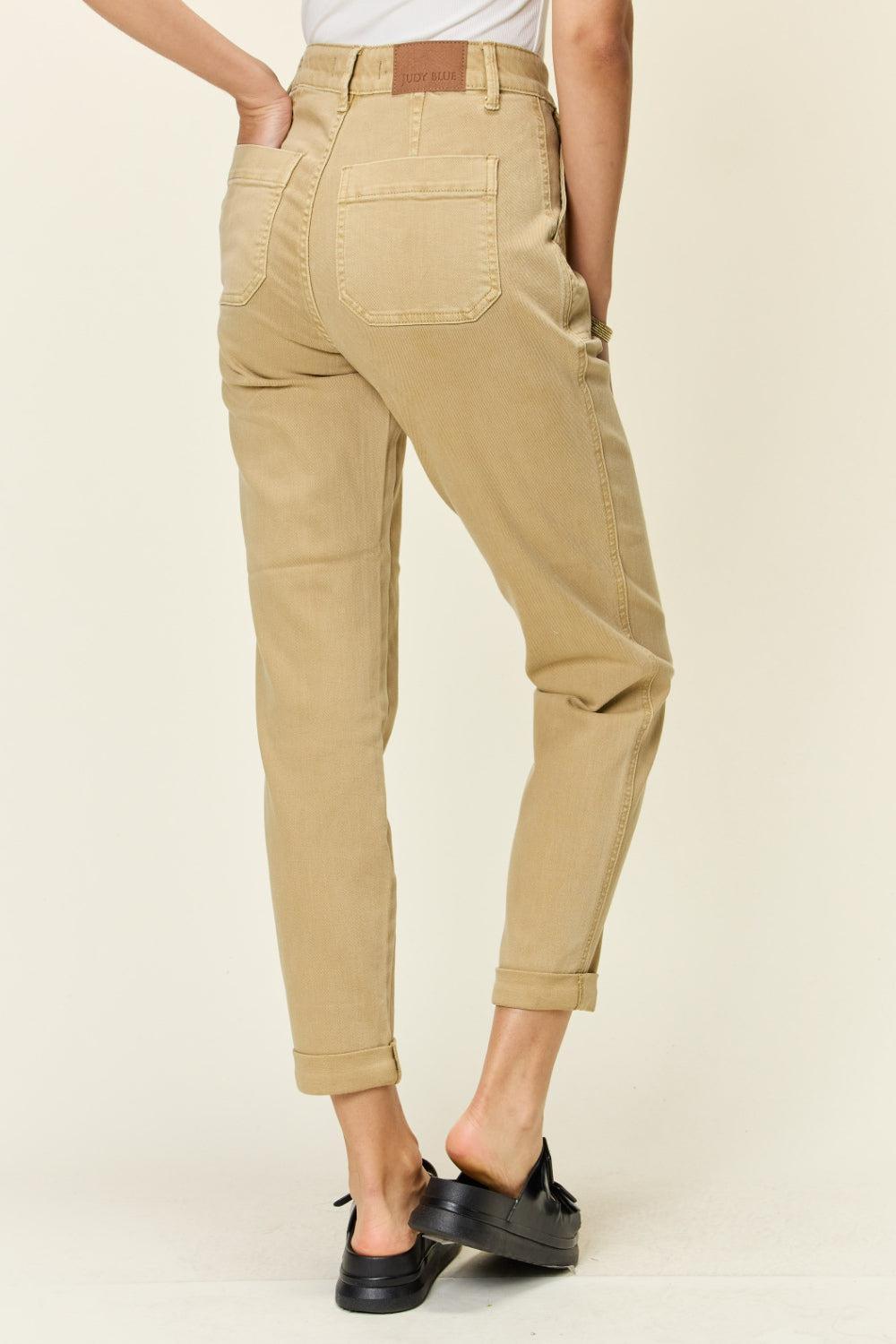 a woman in a white shirt and khaki pants
