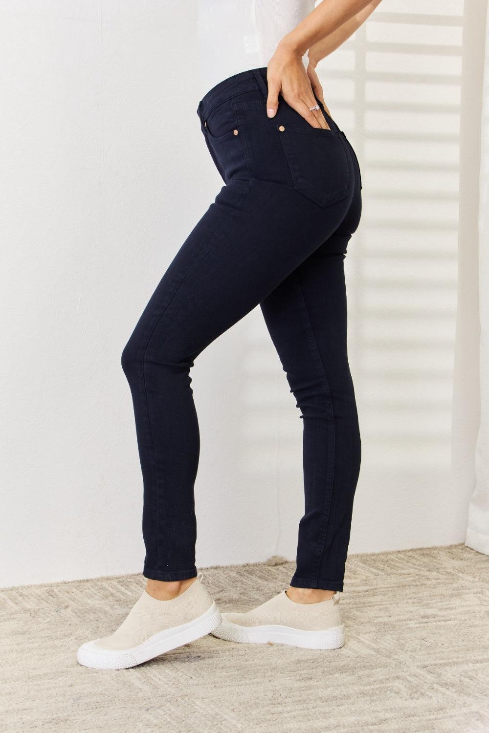 a woman in white shirt and black jeans