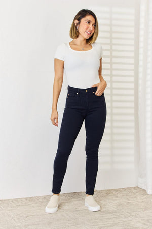 a woman in white shirt and jeans posing for a picture