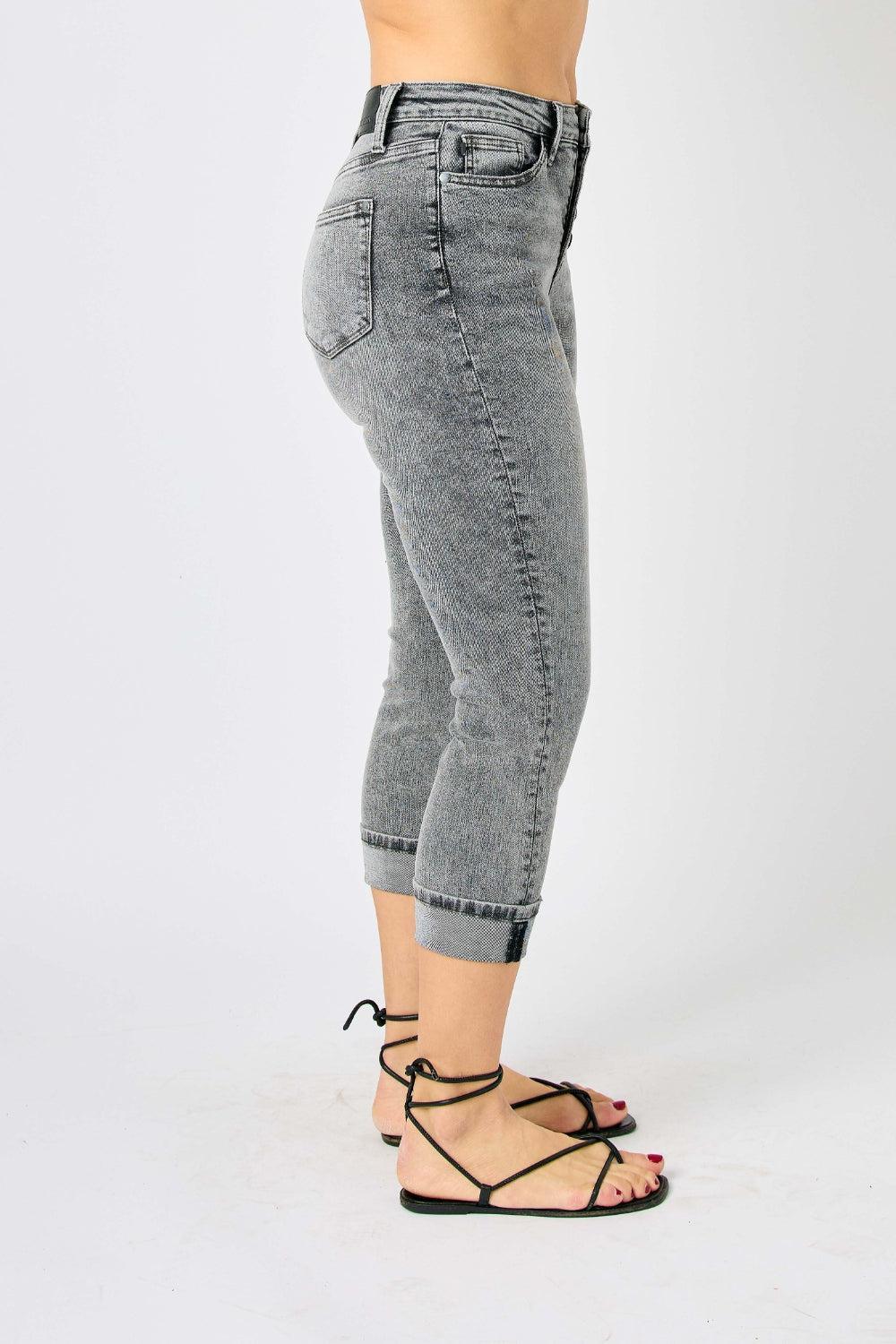 a woman in high heels is standing with her hands in her pockets