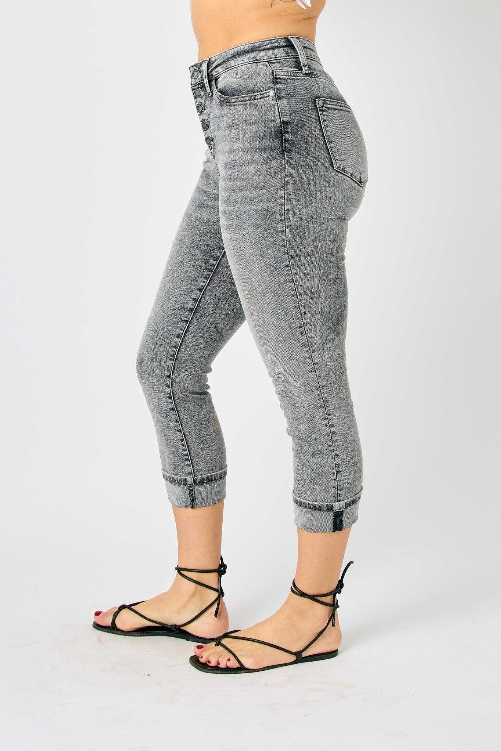 a woman in high heels and jeans posing for a picture