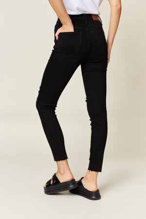 a woman wearing black jeans and a white shirt