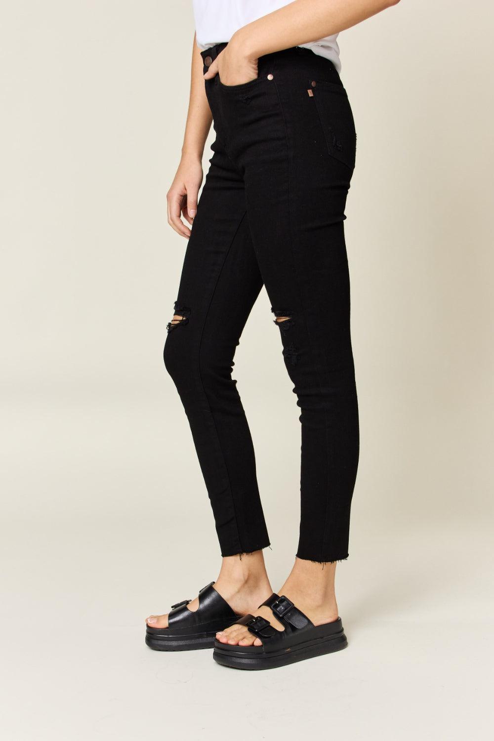 a woman in a white shirt and black jeans