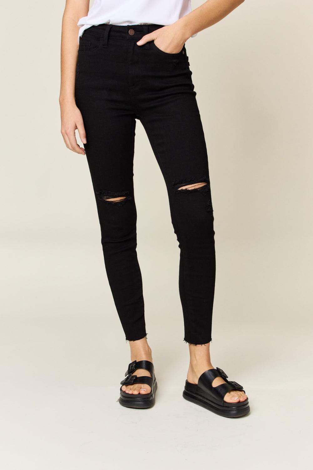 a woman in a white shirt and black jeans