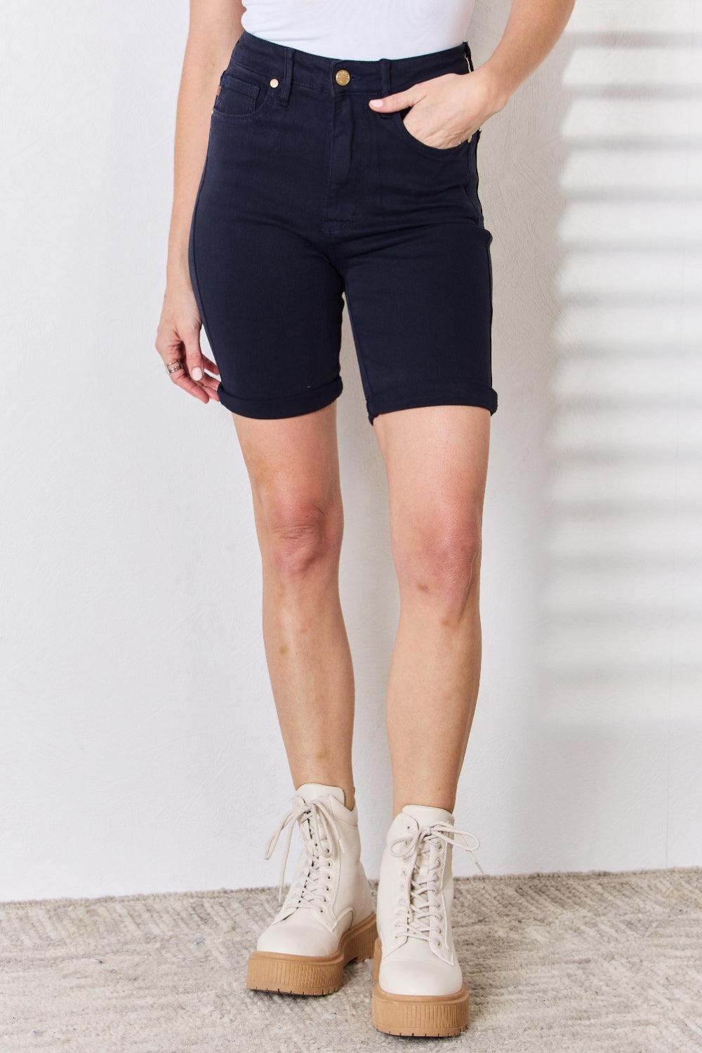 a woman wearing shorts and a tank top