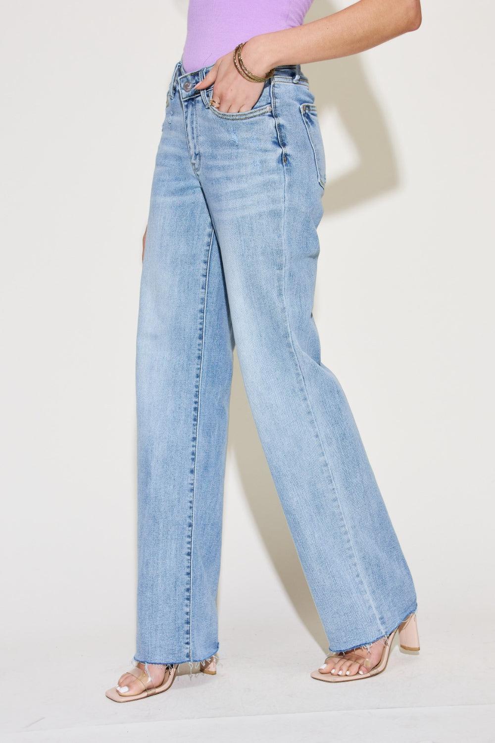 a woman in a purple shirt and blue jeans