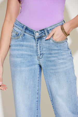 a woman wearing a purple shirt and jeans