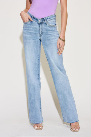 a woman in a purple shirt and jeans