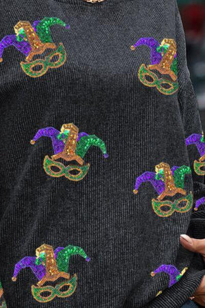 a close up of a person wearing a sweater with a pattern on it