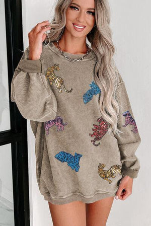 a woman wearing a sweater with a horse on it