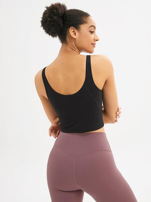 a woman in a black top and purple leggings
