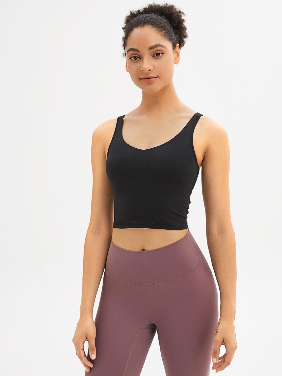 a woman in a black top and purple leggings