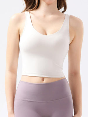 a woman wearing a white top and purple shorts