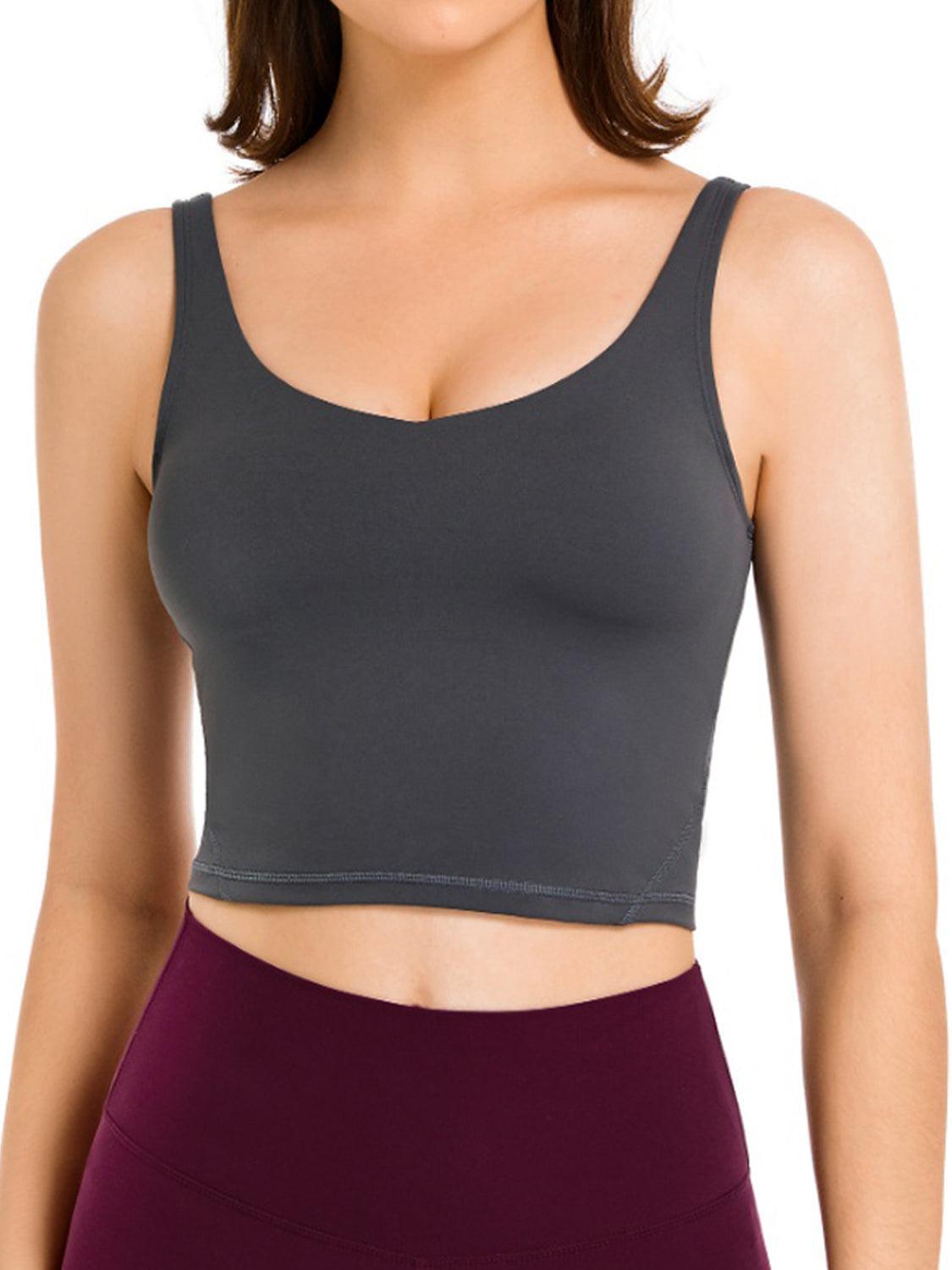 a woman wearing a gray crop top and maroon skirt