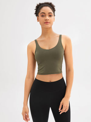 a woman in a green crop top and black leggings