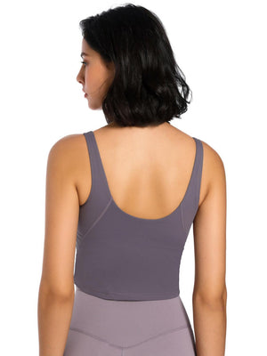 the back of a woman wearing a gray sports bra