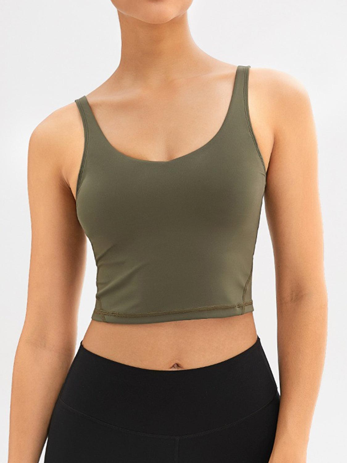a woman wearing a green crop top and black leggings