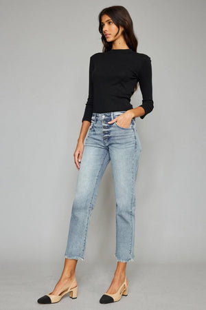 a woman wearing a black top and jeans