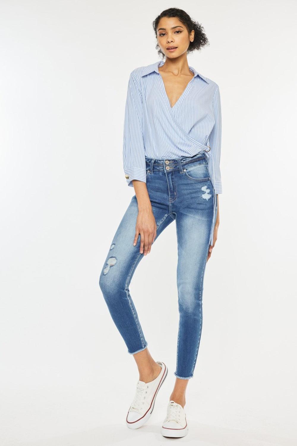 a woman in a blue shirt and jeans