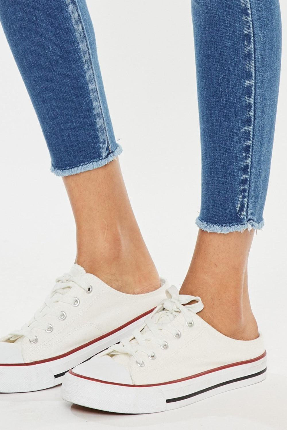 a close up of a person wearing white sneakers