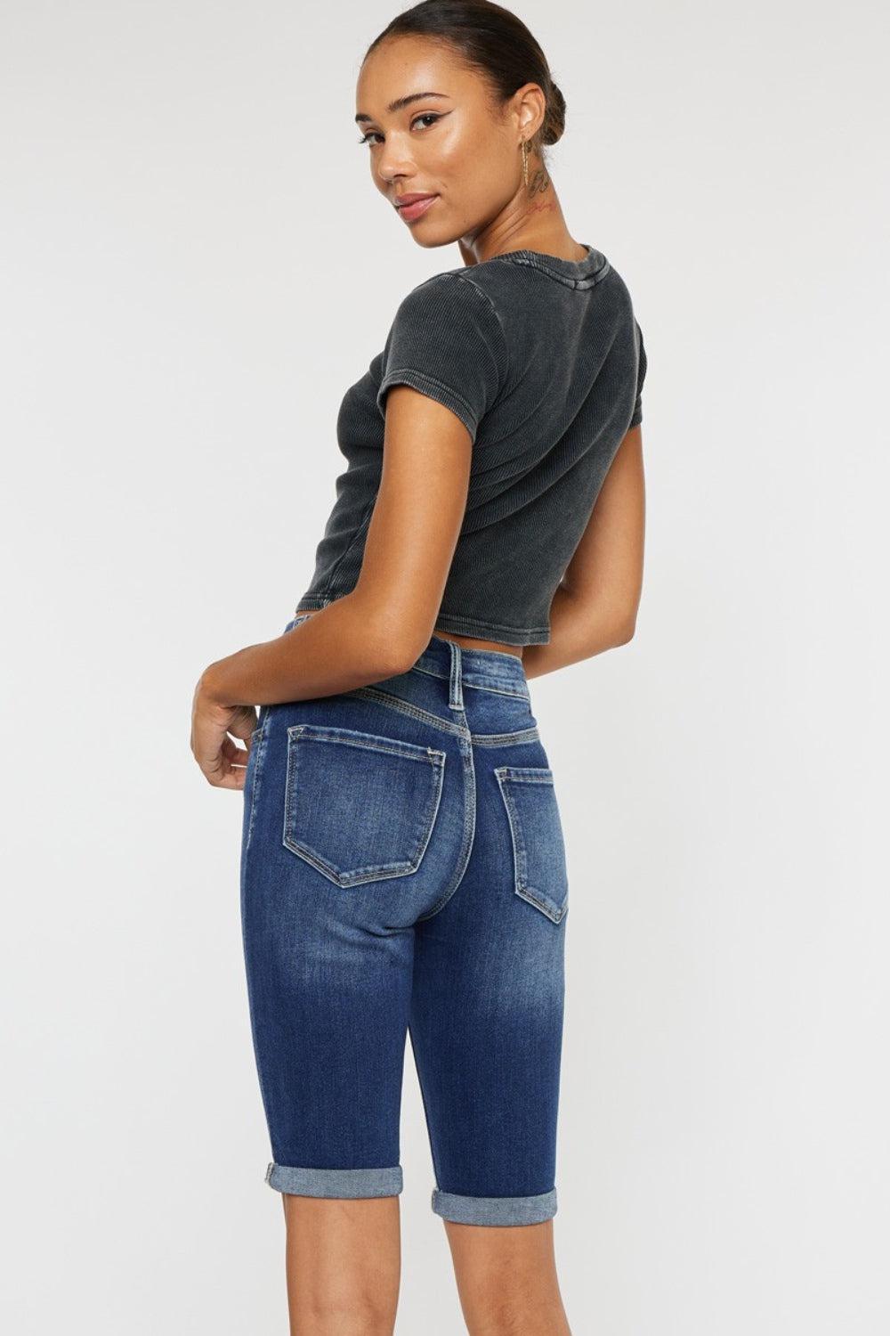 a woman in a black shirt and blue shorts
