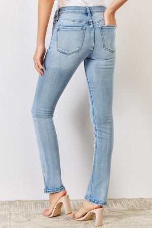 a woman in a white shirt and blue jeans