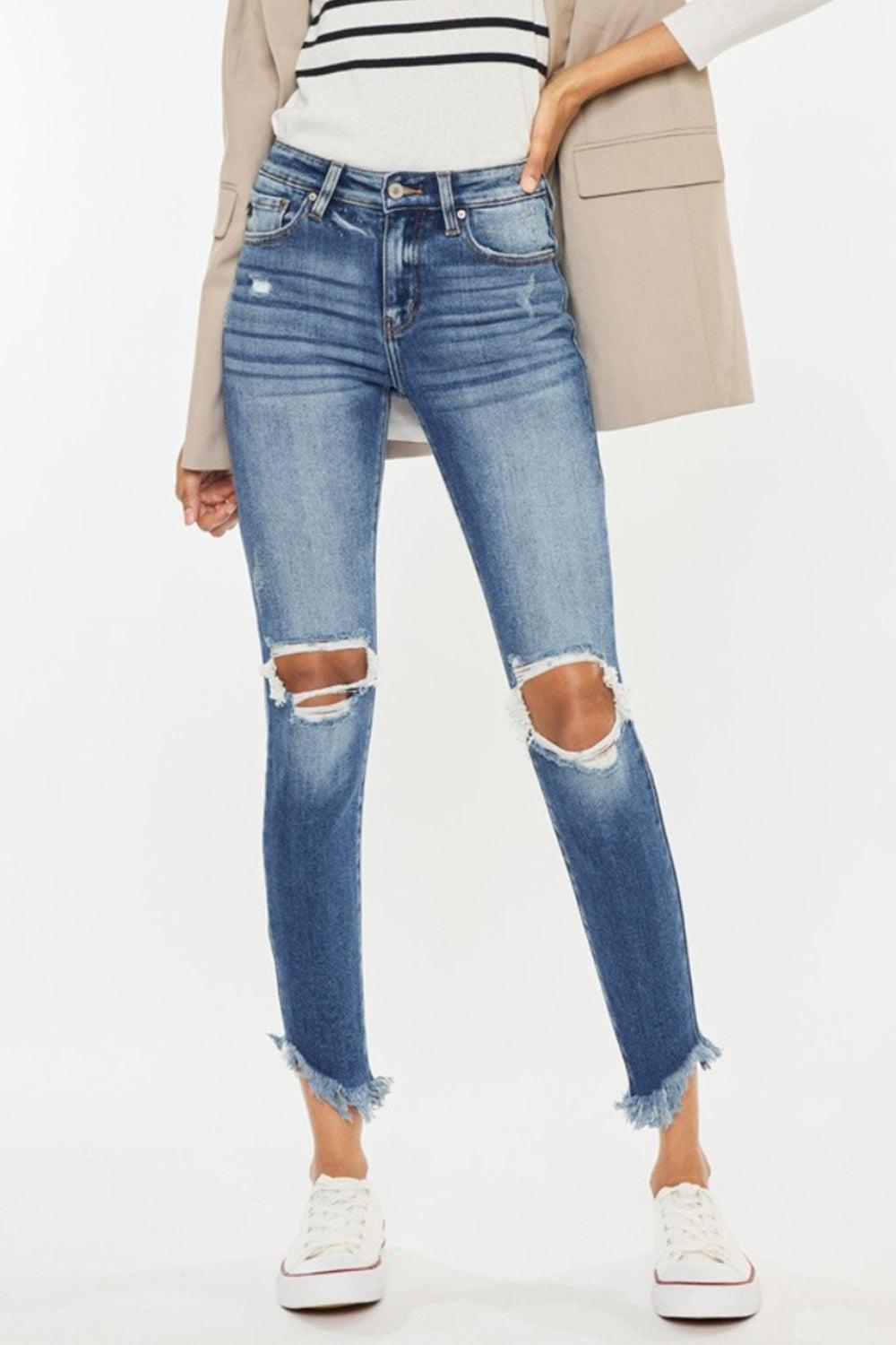 a woman wearing ripped jeans and a jacket
