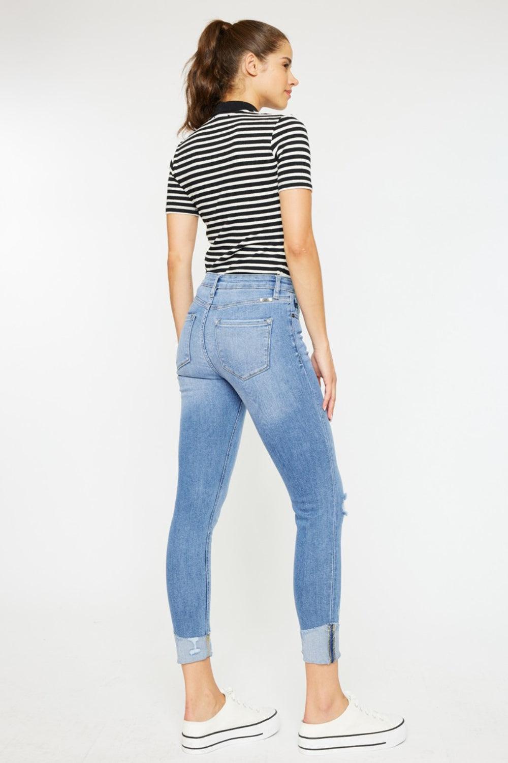 a woman in a striped shirt and jeans