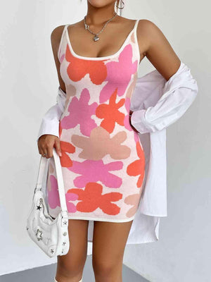 a woman in a pink and white dress holding a white purse