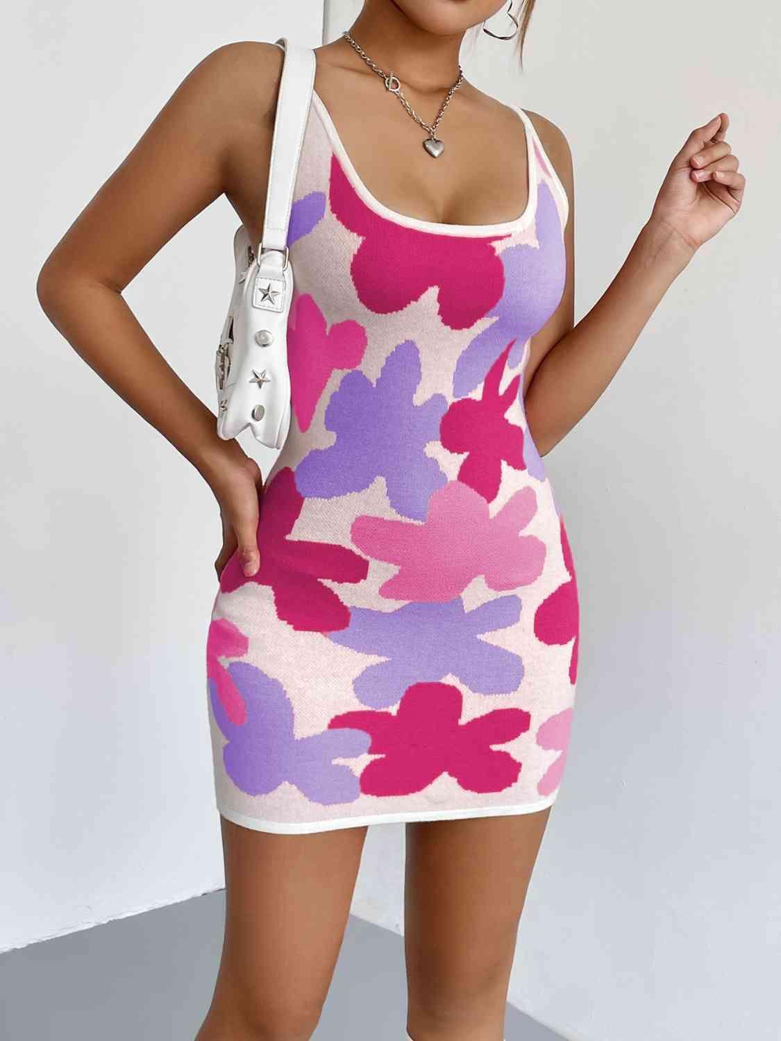 a woman posing in a pink and purple dress