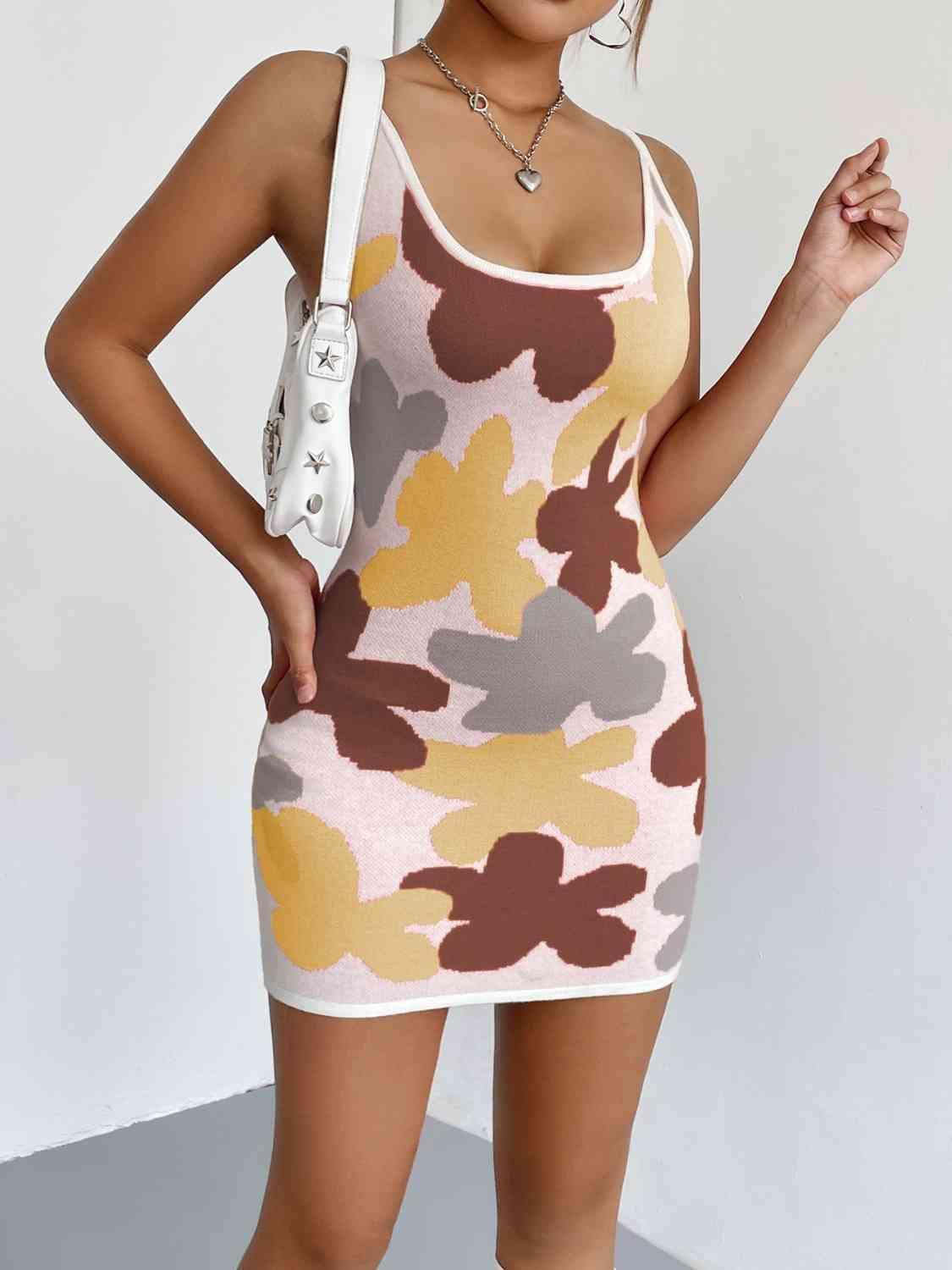 a woman posing in a camo print dress