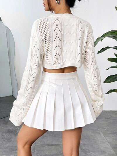 a woman in a white top and a white skirt