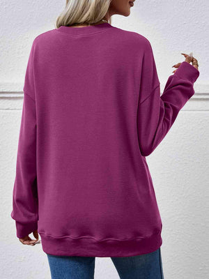 a woman wearing a purple sweatshirt and jeans