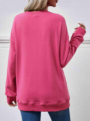 a woman wearing a pink sweatshirt and jeans