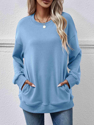 a woman wearing a blue sweatshirt and jeans