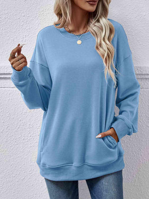 a woman wearing a blue sweatshirt and jeans