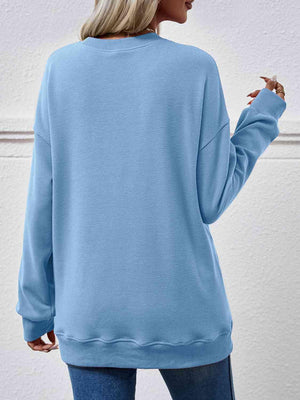 a woman wearing a blue sweatshirt and jeans
